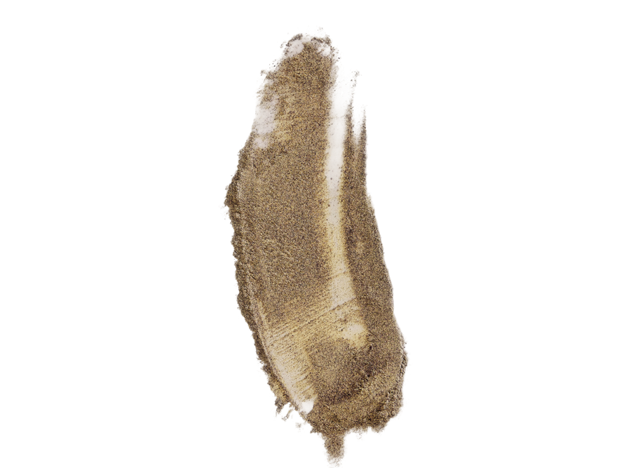 Long smeared brown powder makeup swatch with granular texture on black background