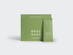 Front view of Ginger and Lime Refill box and sachet showing green Broc Shot packaging and white logo on light gray background